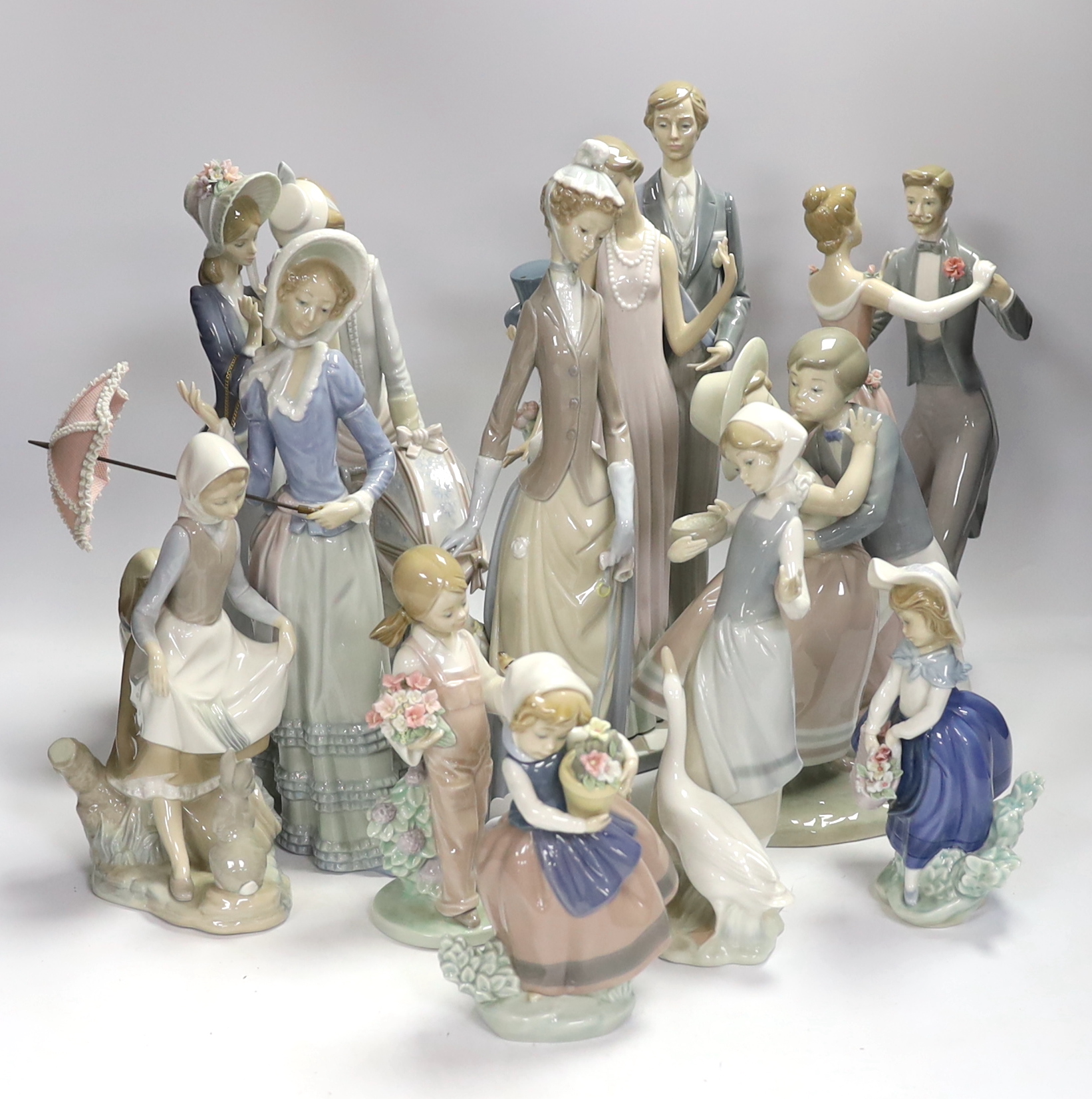 Collection of twelve Lladro figures including Precious Love and High Society